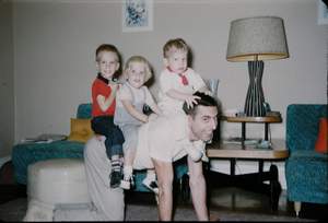 Riding Dad in McPherson Livingroom Bill Ann Rick Picture 481