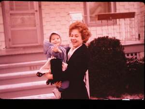 Sandy with baby in front of McPherson Picture 553